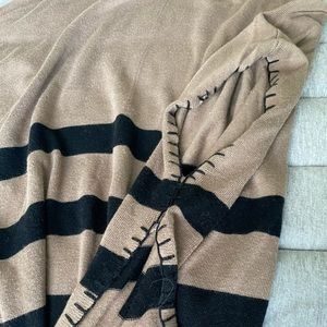 Soft cotton, poncho style sweater. Pairs perfect with black leggings